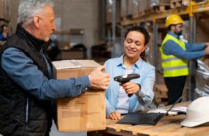 Warehouse staff scanning a package during order fulfillment, representing 3PL logistics operations and the transition toward 4PL-managed supply chains.